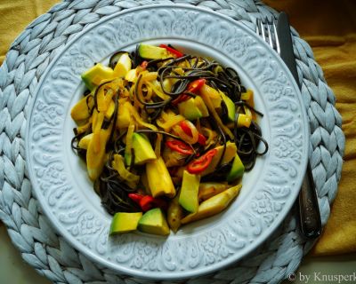 Schwarze Reisnudeln an scharfer Kokos-Safran-Sauce mit gebratenem Spargel und Avocadowürfeln